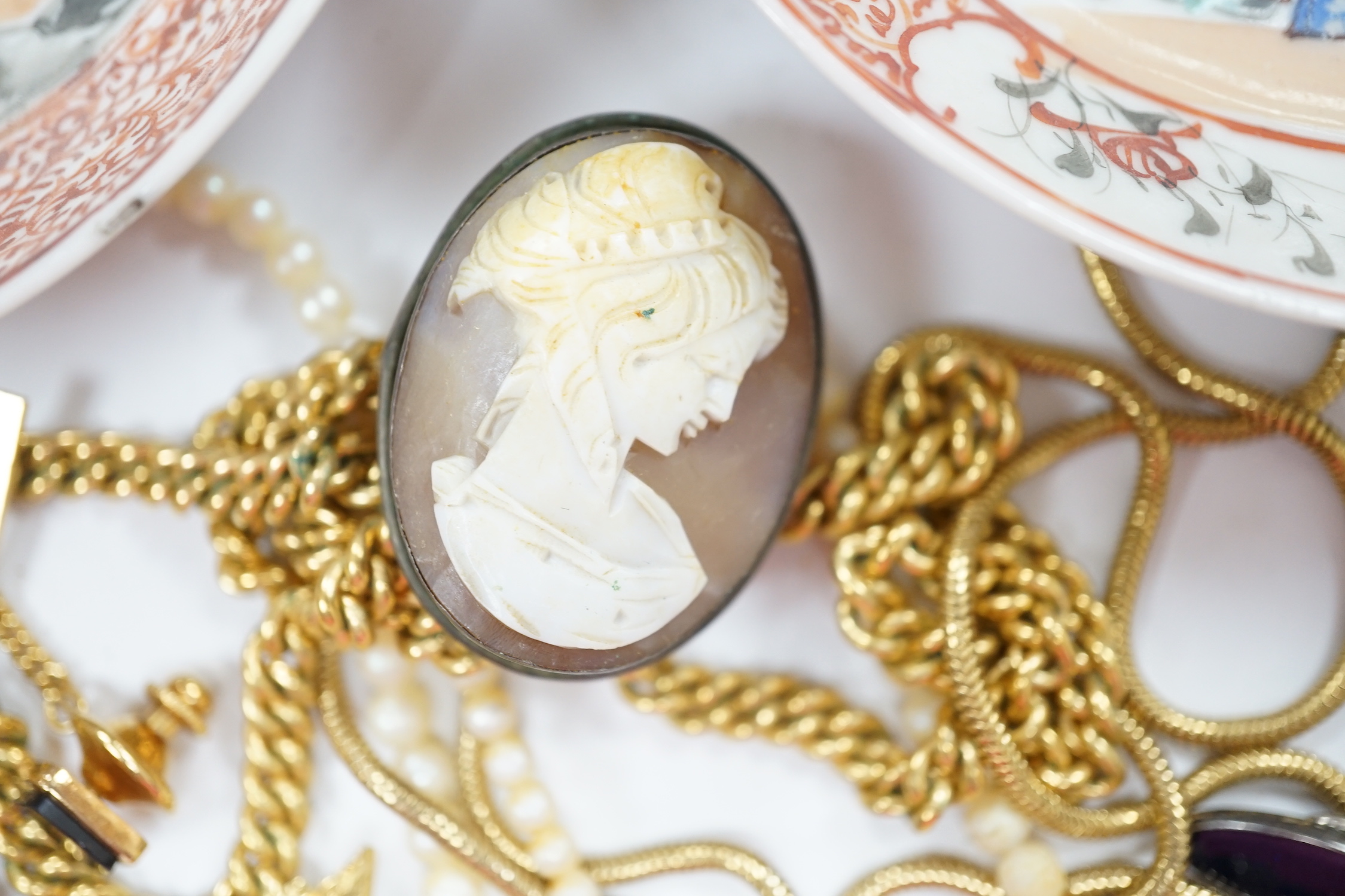 A small 9ct gold and gem set pendant, 22mm, three gilt metal chains, two white metal cufflinks, a Citizen watch, other costume jewellery and three ceramic items.